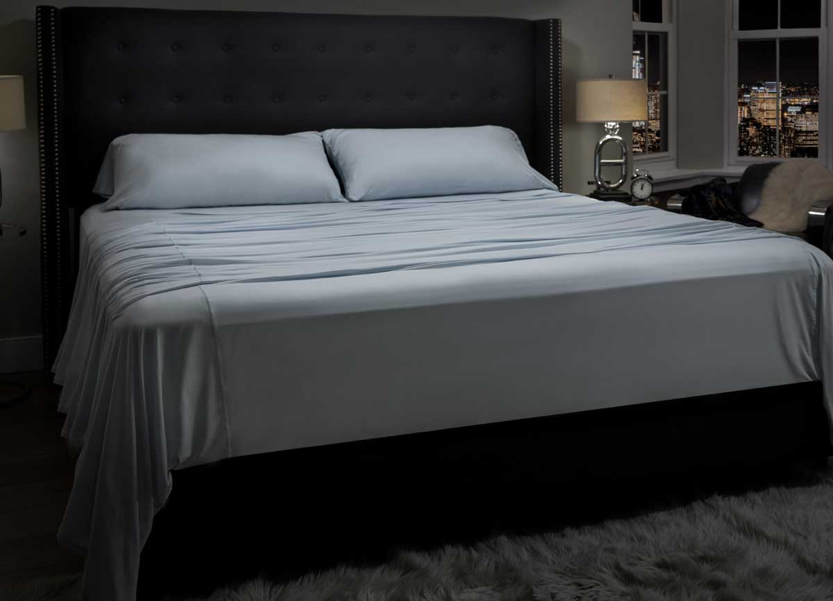  lifestyle image of MIDNIGHT LABEL Flat Sheet shown in spa blue #choose-your-color_spa-blue