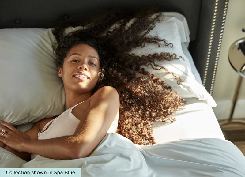 midnight label pillowcase  model in bed #choose-your-color_spa-blue