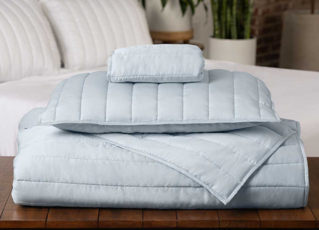 Arctic Coverlet Stack with Bed in Background #choose-your-color_light-blue