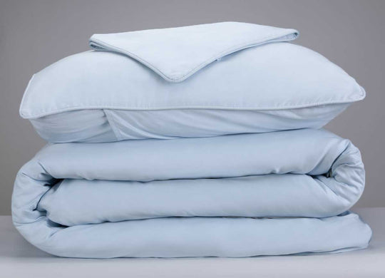 Arctic Aire Duvet Set Image Shown Folded and Stacked in Light Blue #choose-your-color_light-blue