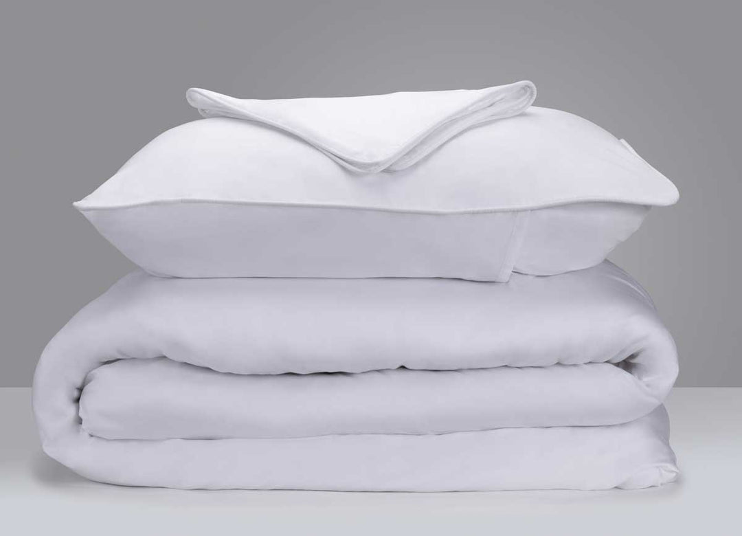 Arctic Aire Duvet Set Image Shown Folded and Stacked in White #choose-your-color_white