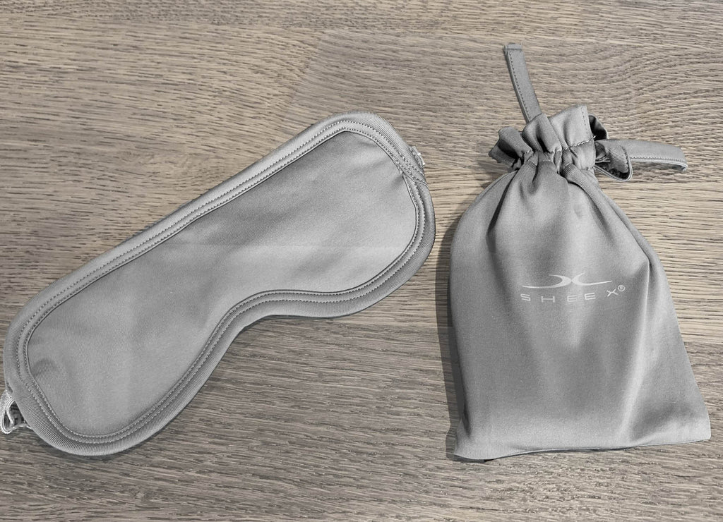 Grey Sleep mask and Pouch on table
