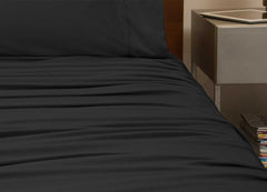 reNEWed Sheet Set on bed in room environment, black #choose-your-color_black