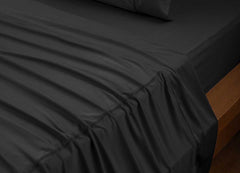 reNEWed Sheet Set on bed in room environment, black #choose-your-color_black