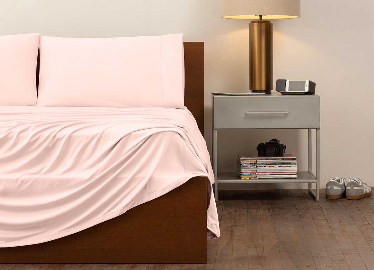 reNEWed Sheet Set on bed in room environment, Blush Pink #choose-your-color_blush-pink