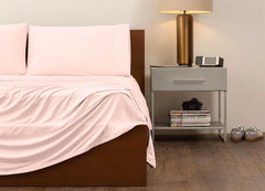 reNEWed Sheet Set on bed in room environment, Blush Pink #choose-your-color_blush-pink