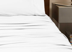 reNEWed Sheet Set on bed in room environment, Bright White #choose-your-color_bright-white