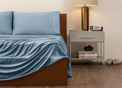 reNEWed Sheet Set on bed in room environment, Carolinia Blue #choose-your-color_carolina-blue