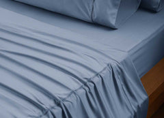 reNEWed Sheet Set on bed in room environment, Carolinia Blue #choose-your-color_carolina-blue
