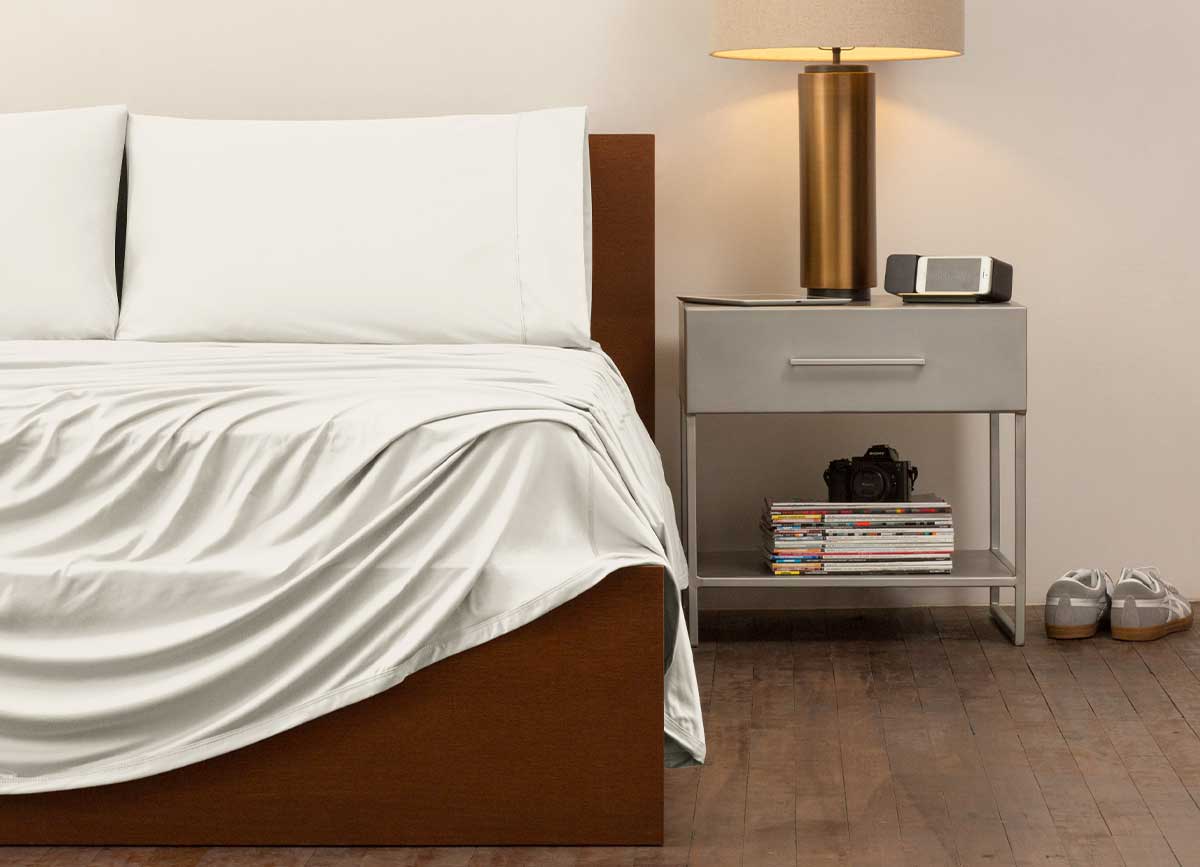 reNEWed Sheet Set on bed in room environment, Bright White #choose-your-color_ecru