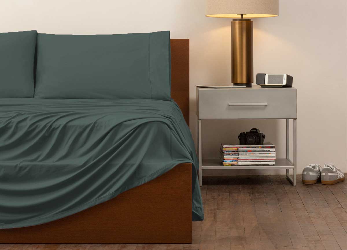 reNEWed Sheet Set on bed in room environment, Forest #choose-your-color_forest