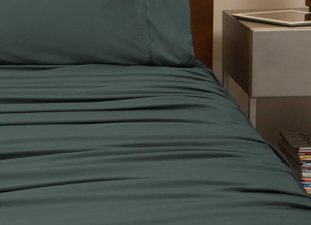 reNEWed Sheet Set on bed in room environment, Forest #choose-your-color_forest