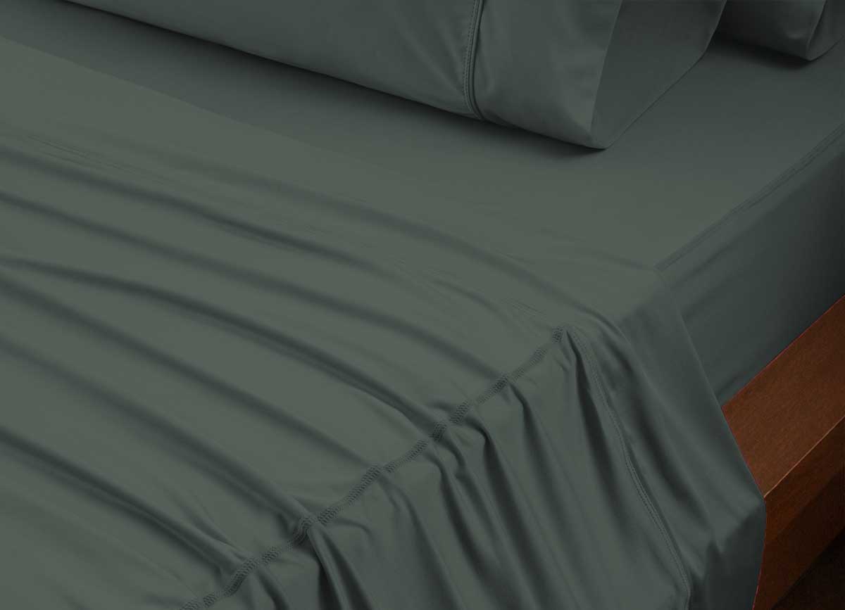 reNEWed Sheet Set on bed in room environment, forest #choose-your-color_forest