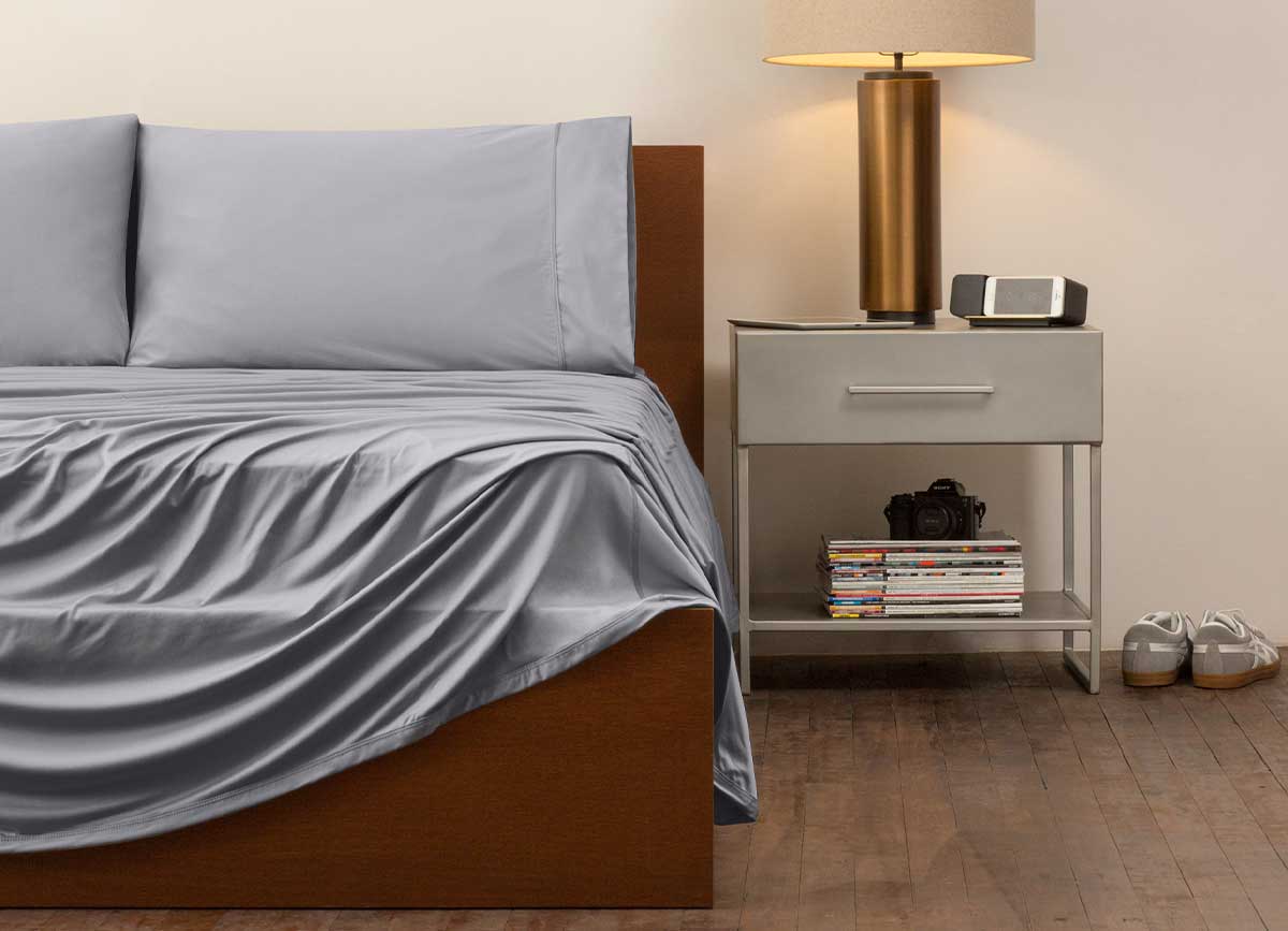 reNEWed Sheet Set on bed in room environment, graphite #choose-your-color_graphite