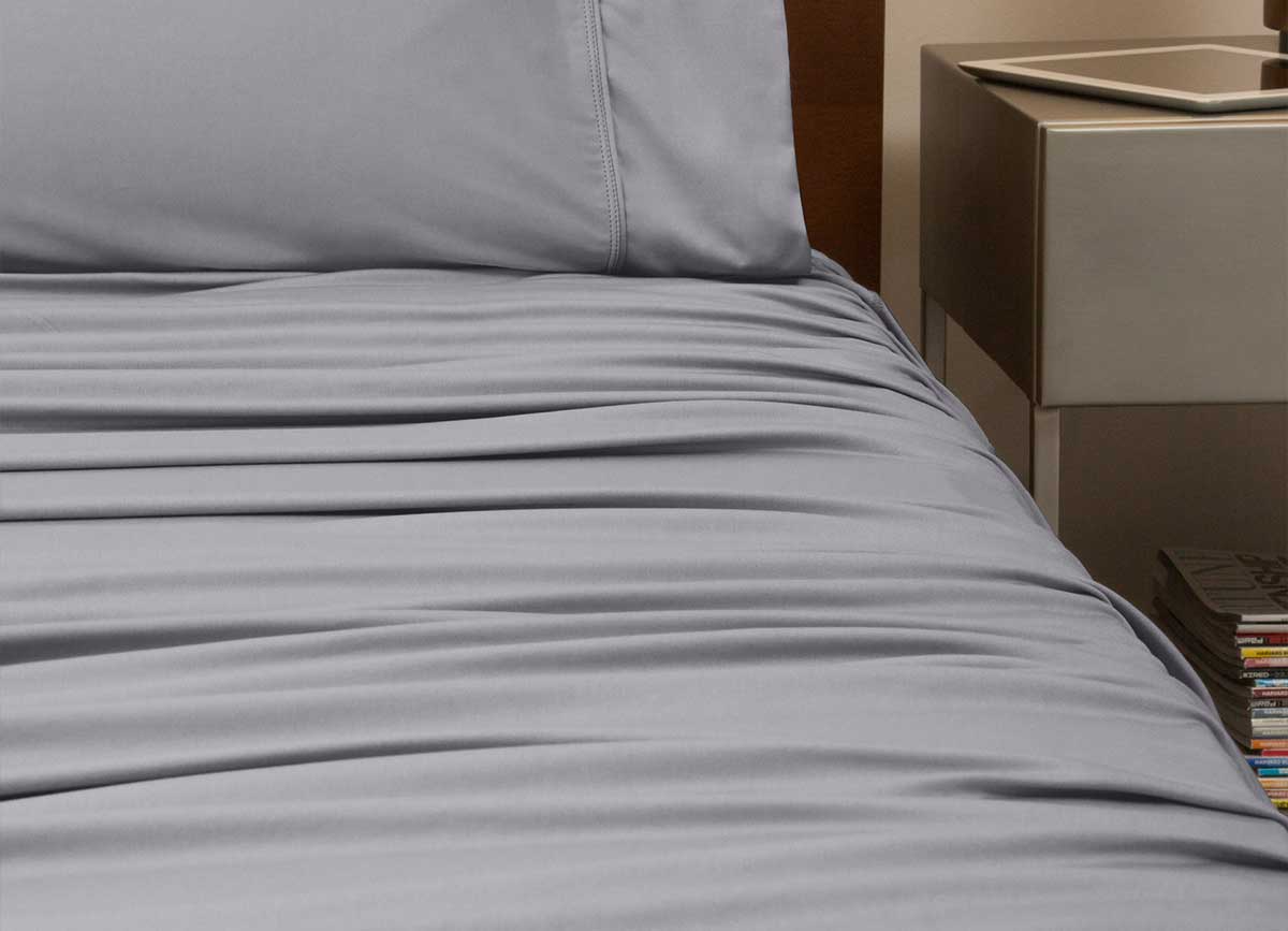 reNEWed Sheet Set on bed in room environment, graphite #choose-your-color_graphite