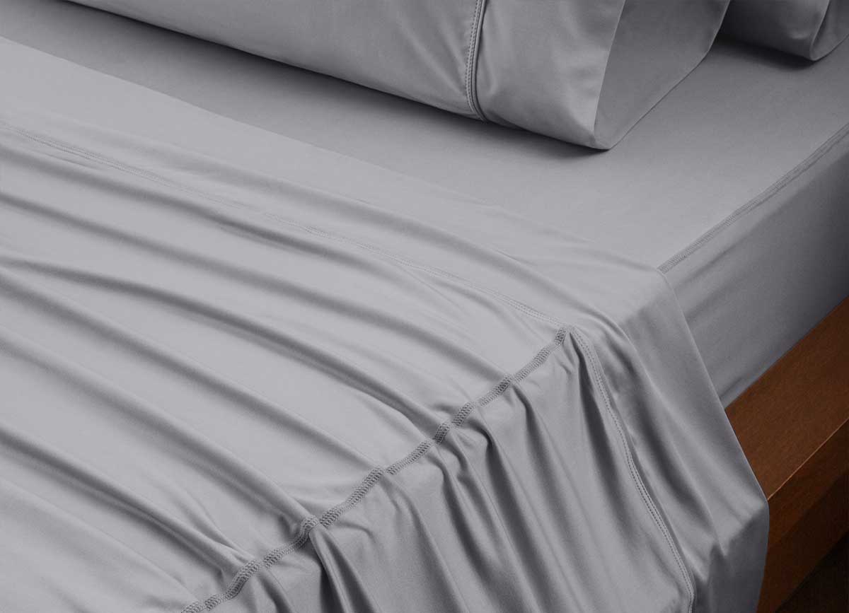 reNEWed Sheet Set on bed in room environment, graphite #choose-your-color_graphite