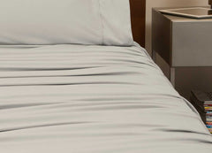 reNEWed Sheet Set on bed in room environment, Khaki #choose-your-color_khaki
