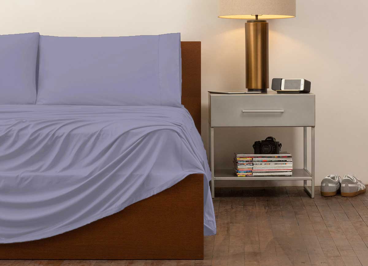 reNEWed Sheet Set on bed in room environment, Lavender #choose-your-color_lavender