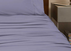 reNEWed Sheet Set on bed in room environment, Lavender #choose-your-color_lavender