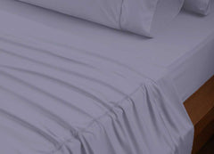 reNEWed Sheet Set on bed in room environment, Lavender #choose-your-color_lavender