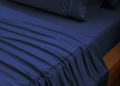 reNEWed Sheet Set on bed in room environment, Navy #choose-your-color_navy