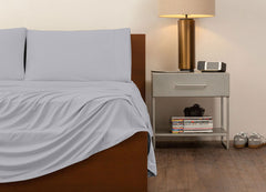reNEWed Sheet Set on bed in room environment, Pearl Blue #choose-your-color_pearl-blue
