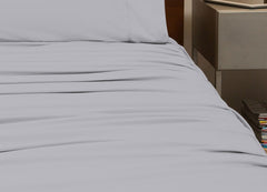 reNEWed Sheet Set on bed in room environment, Pearl Blue #choose-your-color_pearl-blue