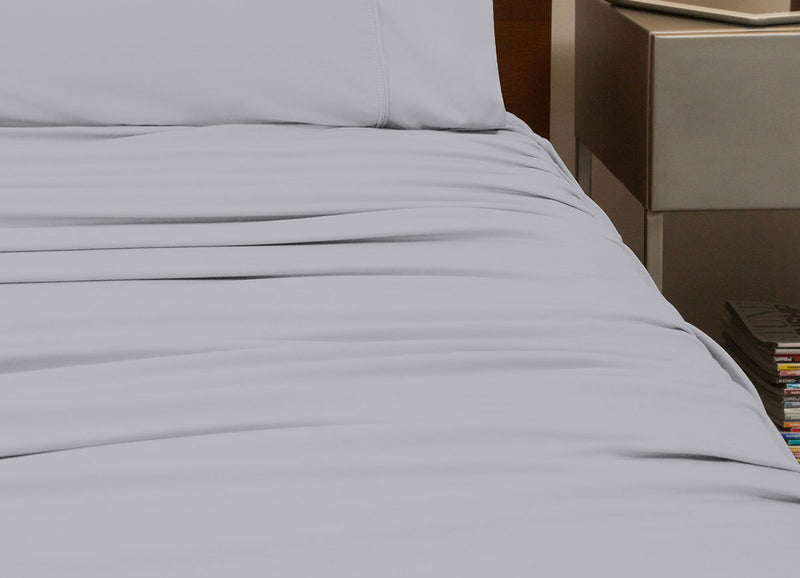 reNEWed Sheet Set on bed in room environment, Pearl Blue #choose-your-color_pearl-blue