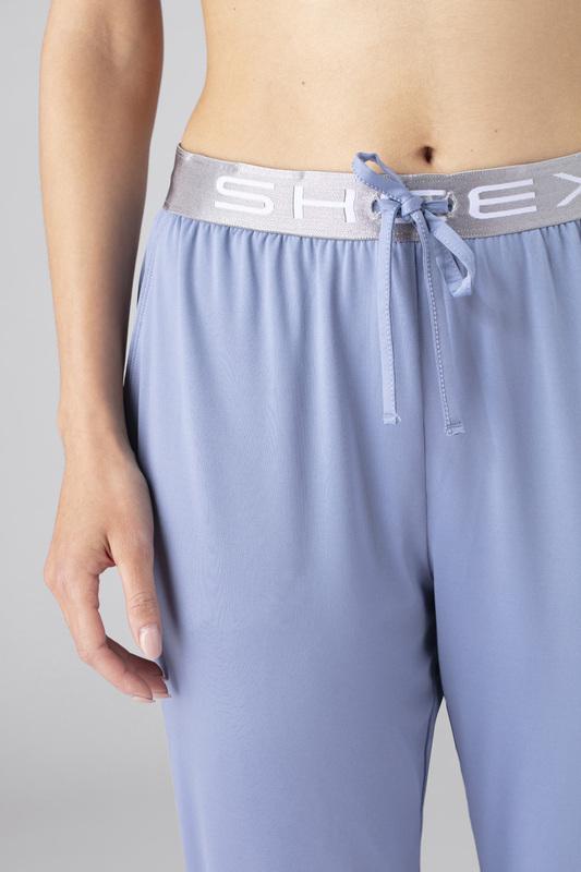 Close up detail image of model wearing SHEEX Women's Modern Jogger in light-blue #choose-your-color_light-blue