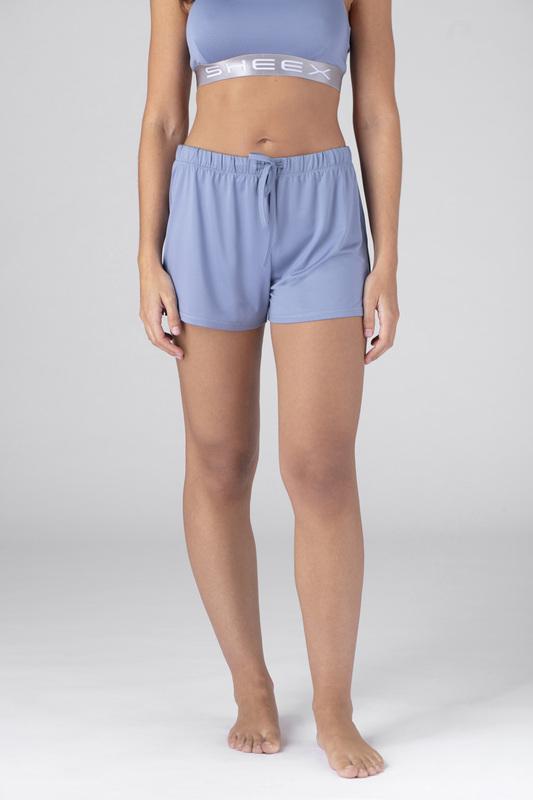 Model wearing SHEEX Women's P.J. Shorts in Light-Blue#choose-your-color_light-blue
